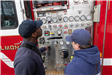 Firefighters Look at Gauges on Fire Truck